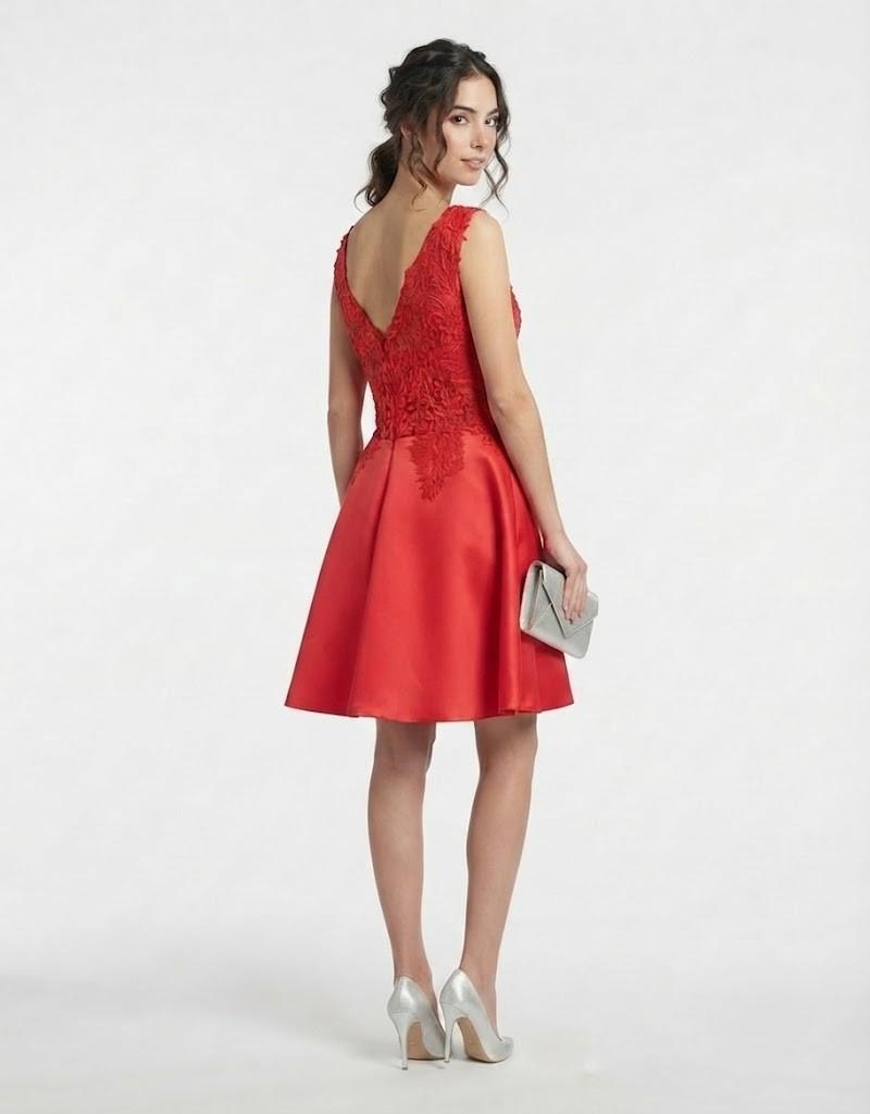 Modelo de espaldas mostrando el escote trasero de vestido corto rojo de fiesta con encaje