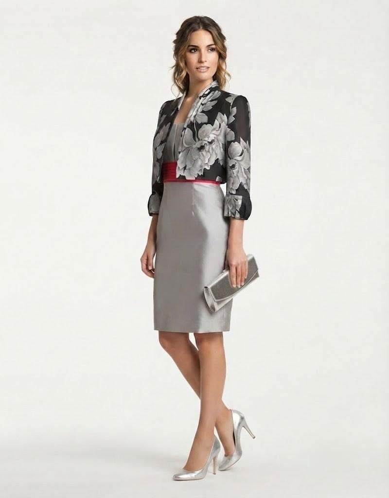 Modelo con vestido gris de ceremonia, fajín rojo y chaqueta corta estampada floral.